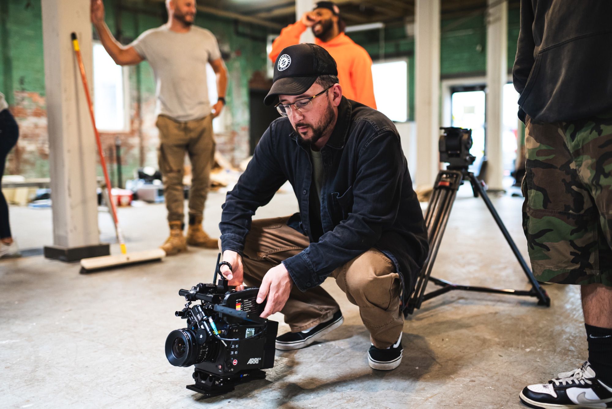 Setting up a handheld shot on a warehouse set